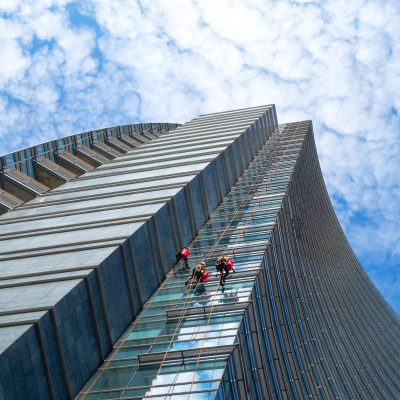 Milan, Italy - September 7 2018: Group of Alpinists in service for windows cleaning of skyscrapers buildings